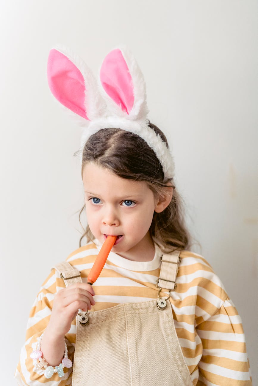 little girl with bunny ears and carrot