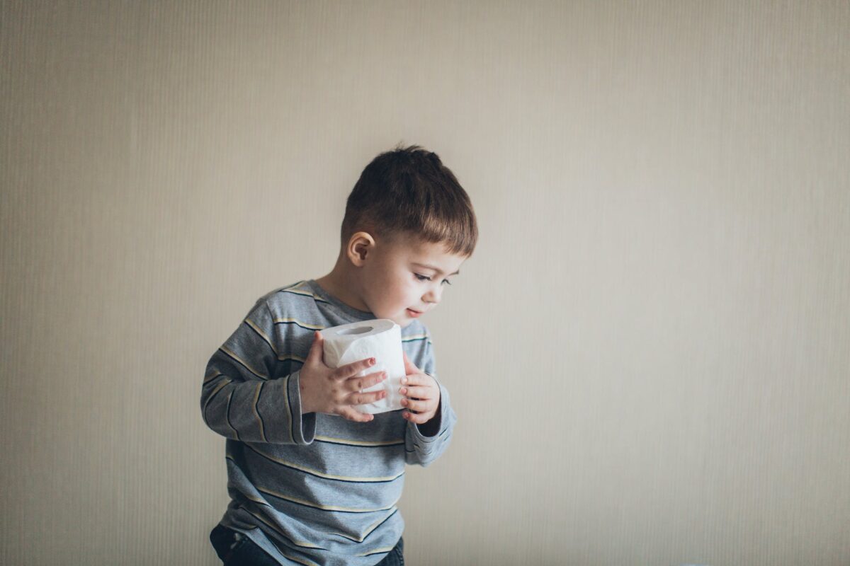 little boy holding tissue roll